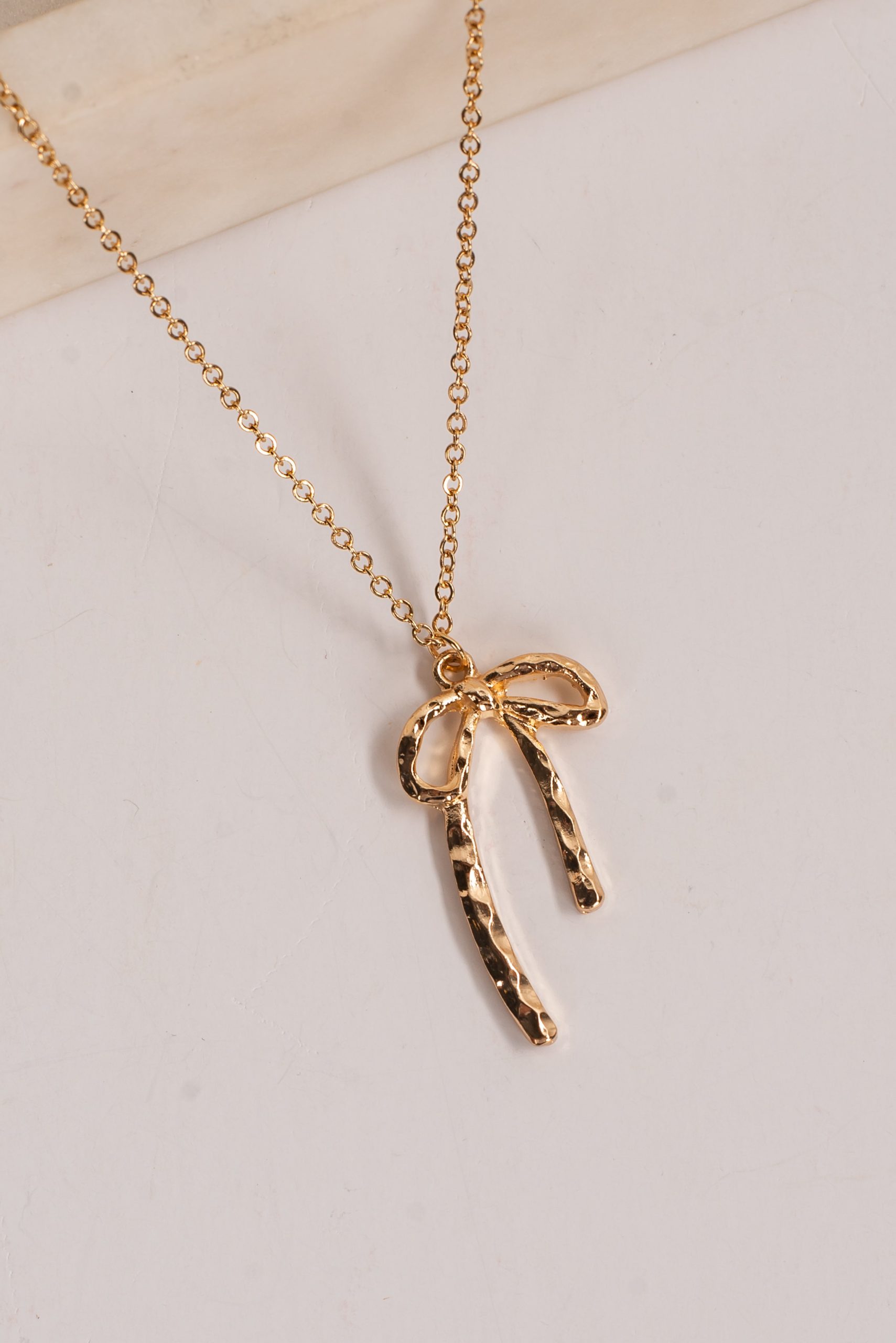 shopdressup_gold_bow_charm_necklace-2_e4c9b871-7fa4-4ed3-9eac-d1b8cdb195af.jpg