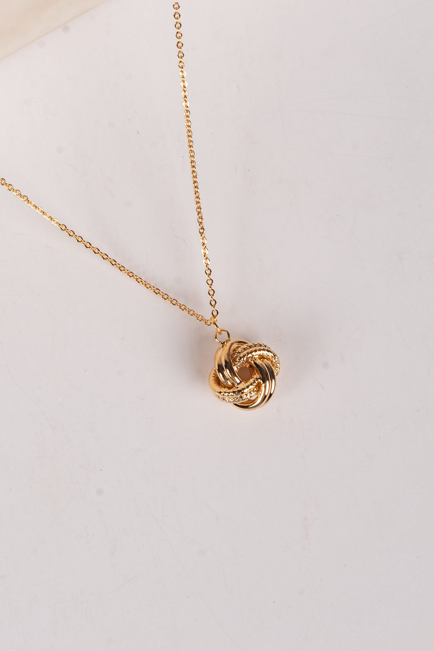 shopdressup_gold_knot_charm_necklace-2_6c0aced6-6cb6-4fde-9f3c-5bb21c6522f2.jpg