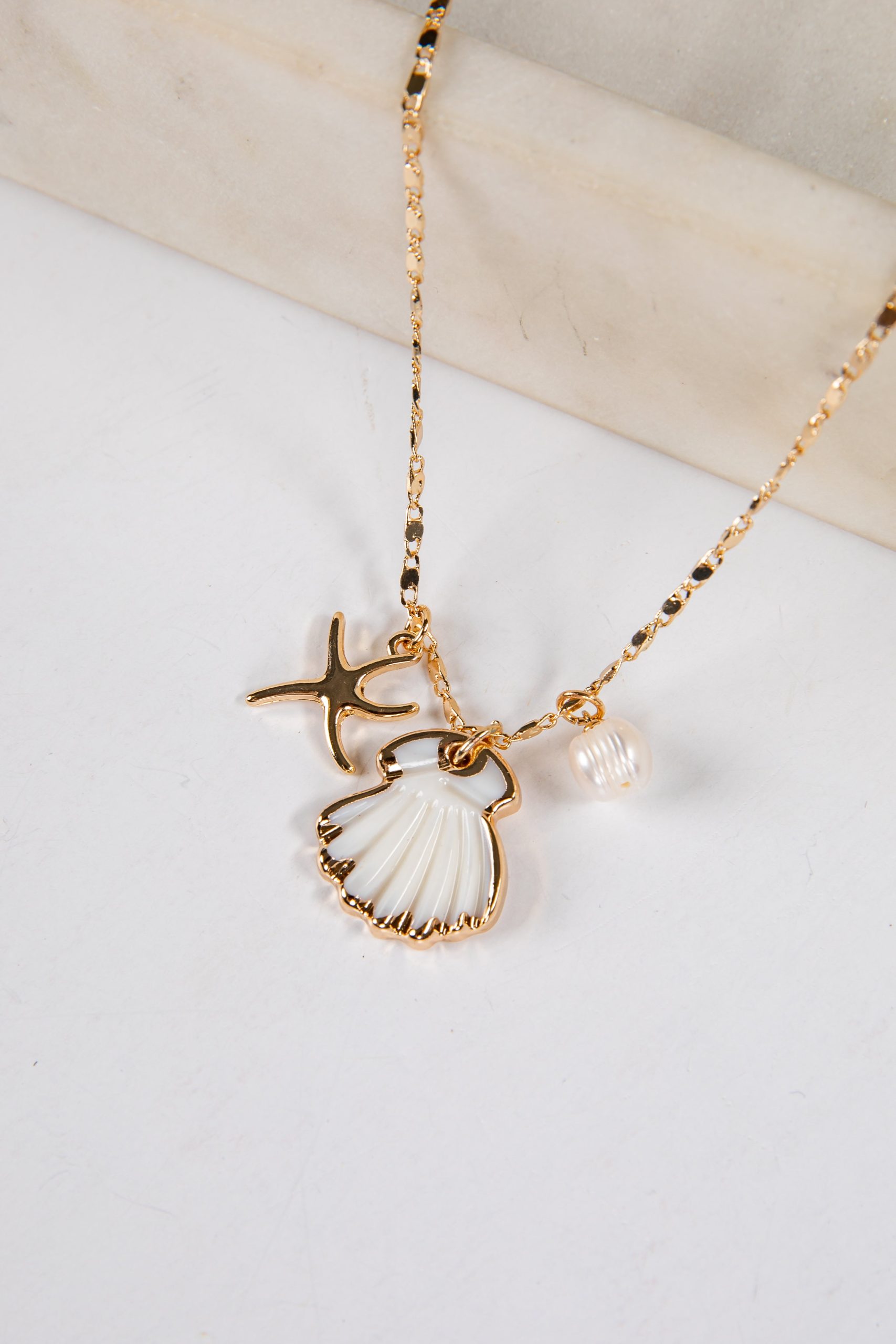 shopdressup_gold_seashell_charm_necklace-2_8a26d94e-2b94-464c-8f70-c58b4f7fd727.jpg